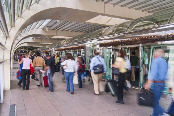Orlando International Airport tram terminal with passengers blurred