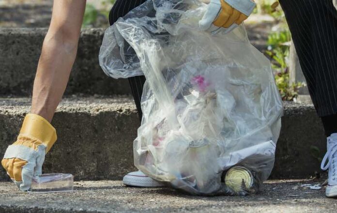 Litter and trash pick up by woman