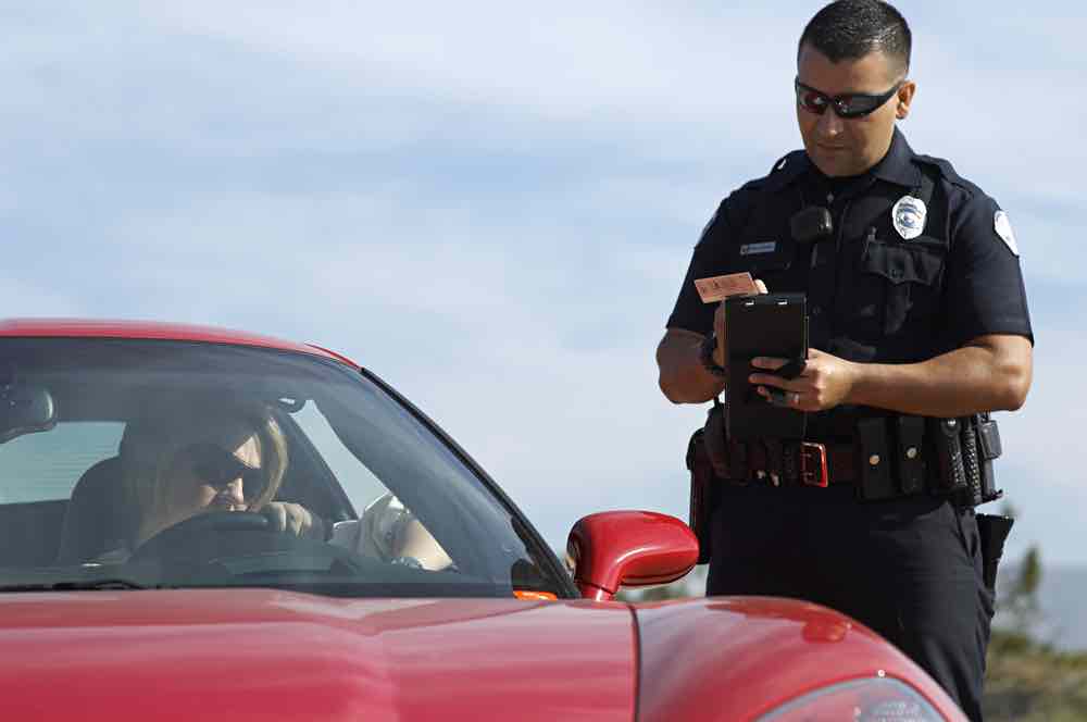 Police officer issuing ticket for no seat belt