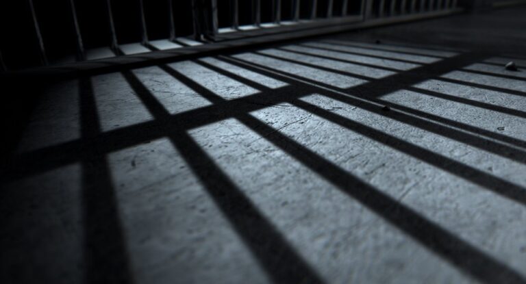 Prison bars on dark background