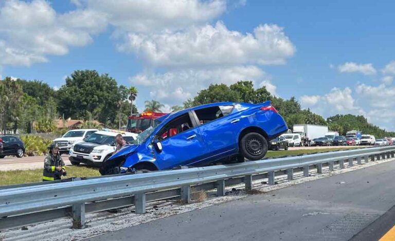 Car lodged over guardrail snares I-4 west
