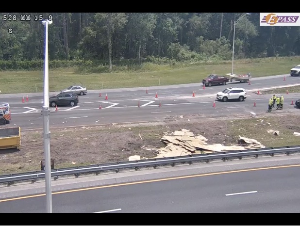 Crews have pushed the plywood off SR 528 and onto the grass shoulder