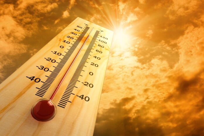 High temperatures on thermometer with sunny background