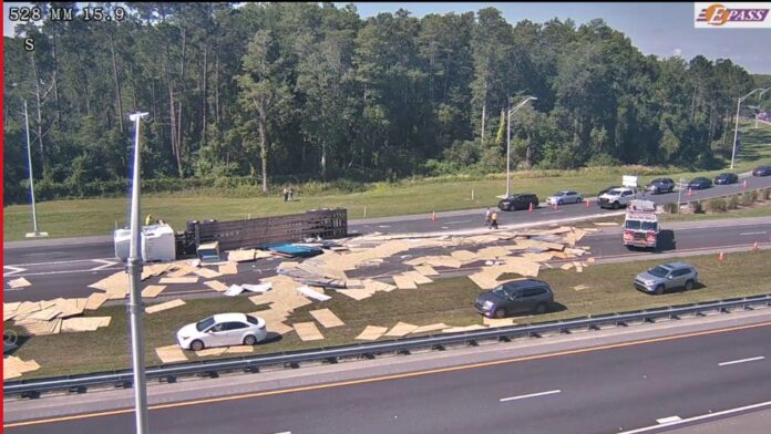 Semi truck overturns dumps plywood onto SR 528 on Wednesday June 8