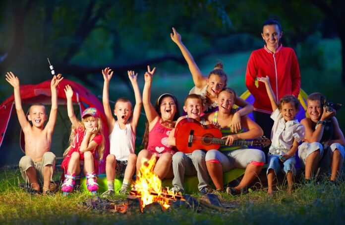 Kids around campfire at summer camp