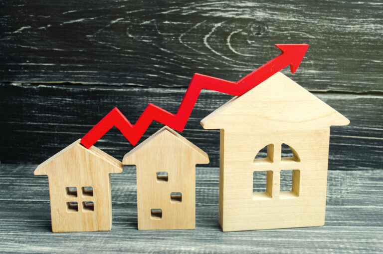 Rental increase represented by wooden houses and red trend arrow