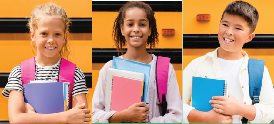 Students with supplies in front of school bus