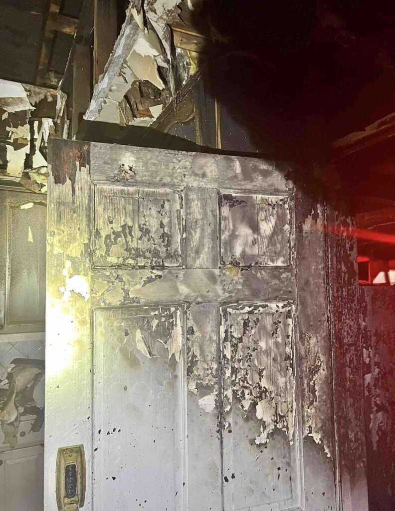 Burned door at house fire on Azalea Lane in Winter Park
