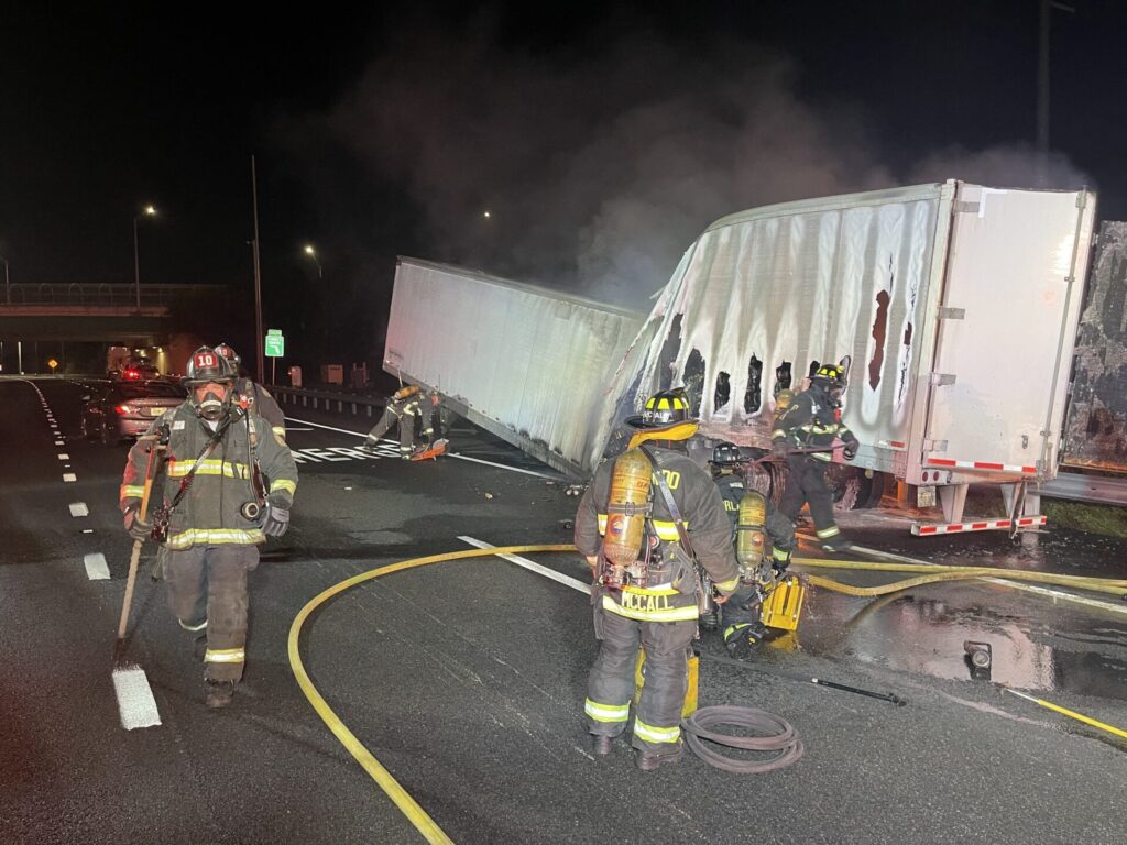 Orlando Fire Department crews work contain fire from semi truck carrying beverages