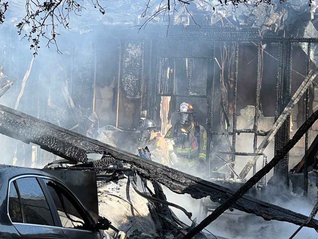 Firefighters walk through scene of home fire in Chuluota on January 10