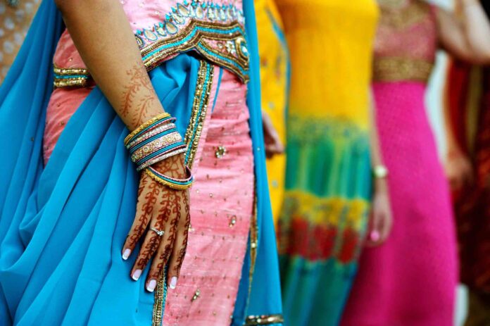 Indian women in saris with henna tattoos