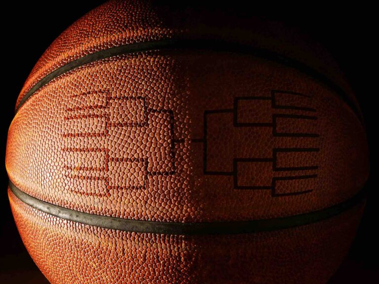 Basketball with tournament brackets NCAA March Madness