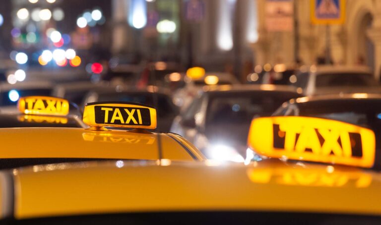 Taxi cab lighted sign on top of car