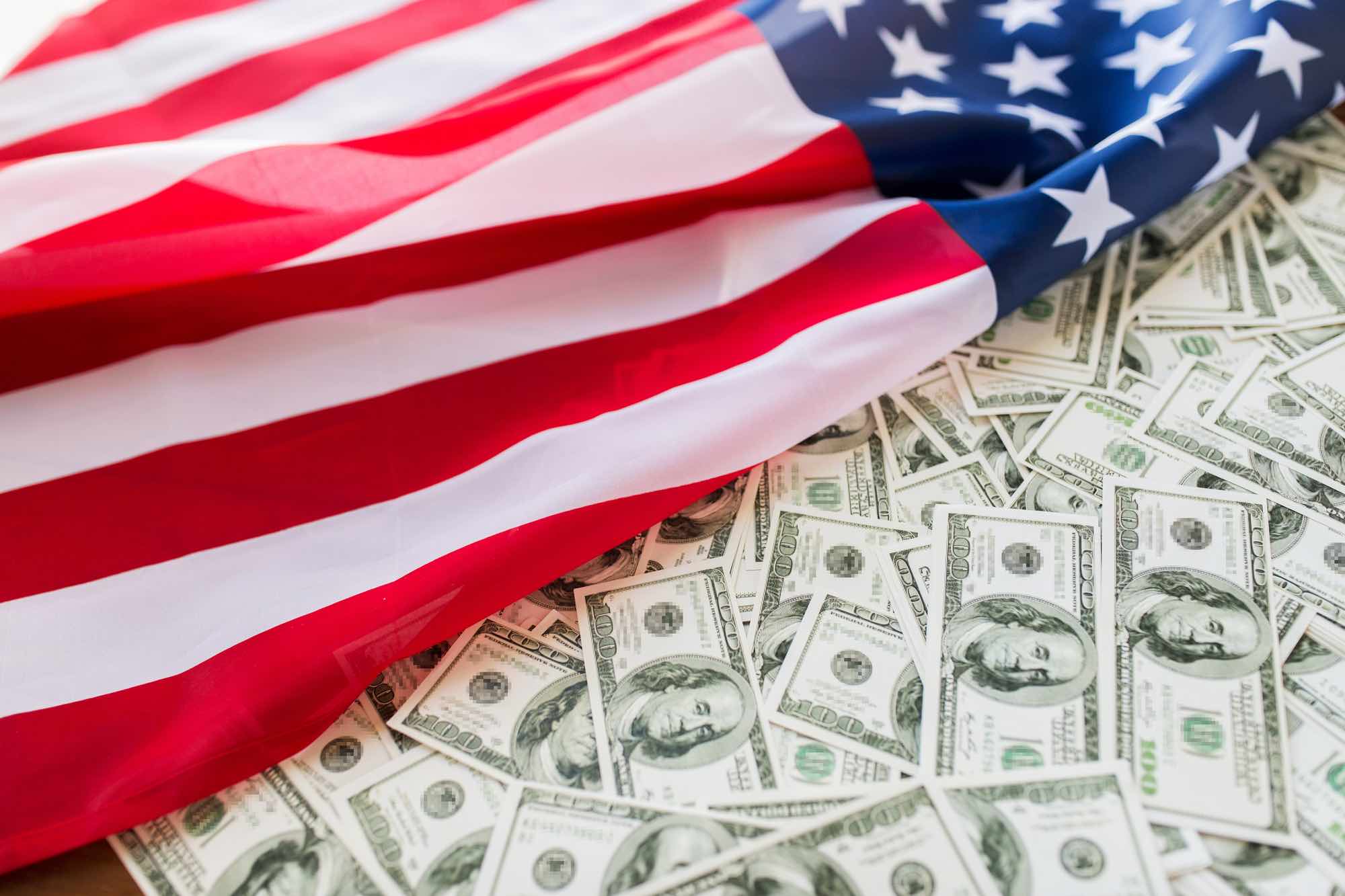 American flag on top of money depicting budget