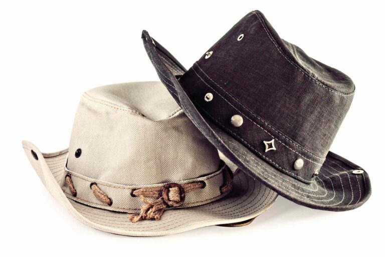 Beige and black cowboy hats isolated on white background