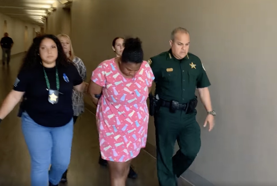 Rachelle Edwards being walked by Osceola County Sheriff Marcos Lopez