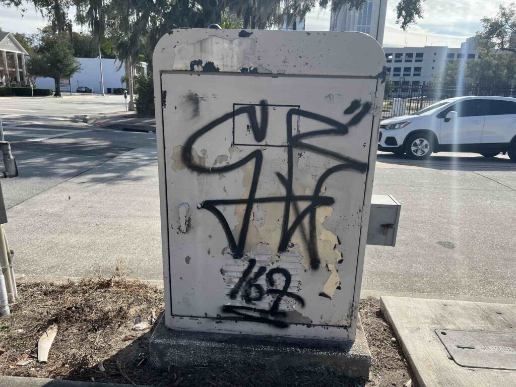 Graffiti on electrical box outside of business in downtown Orlando