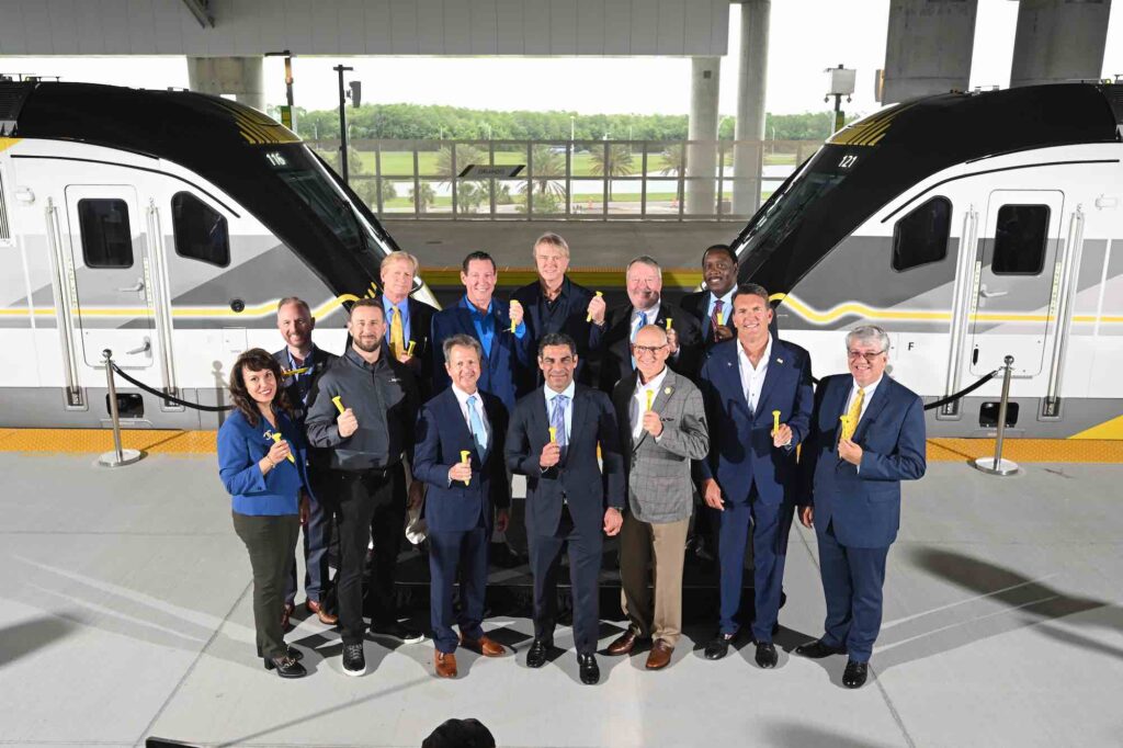 Mayors mark completion of Brightline railway to Orlando with golden spike ceremony