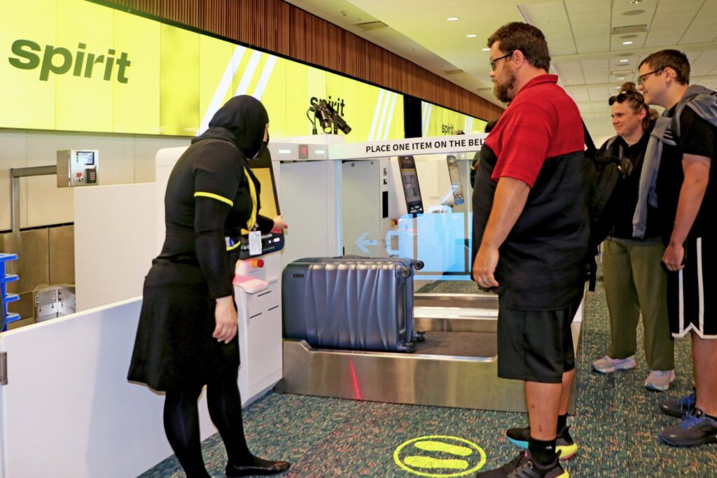 Passenger using new self bag drop for Spirit Airlines at Orlando International Airport
