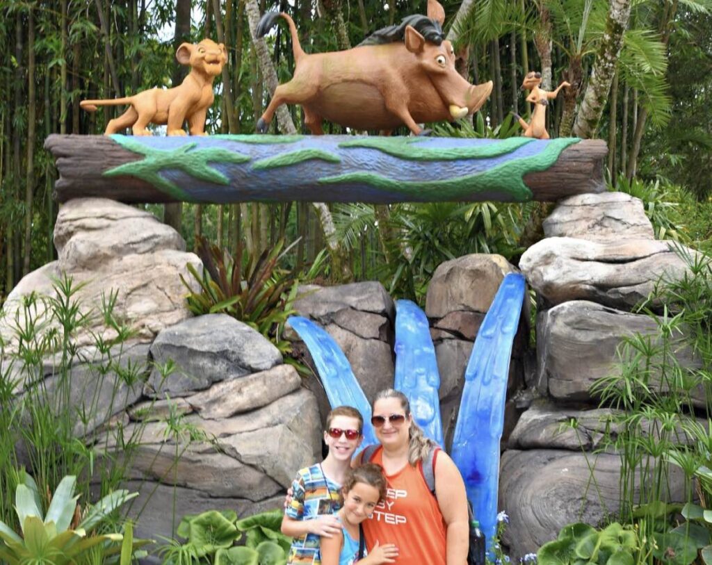 Make A Wish family in front of Lion King characters