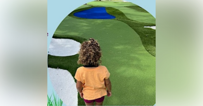 Child on mini golf course