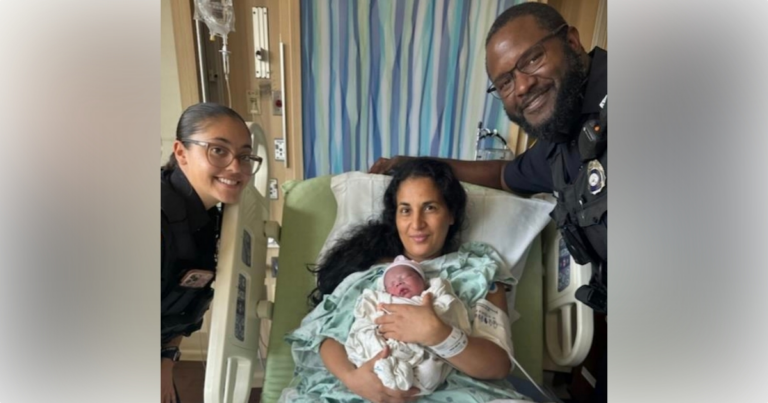 Recruit Officer Laura Crespo (left) and Officer Adsudalah Brooks (right) with the mother and her baby boy