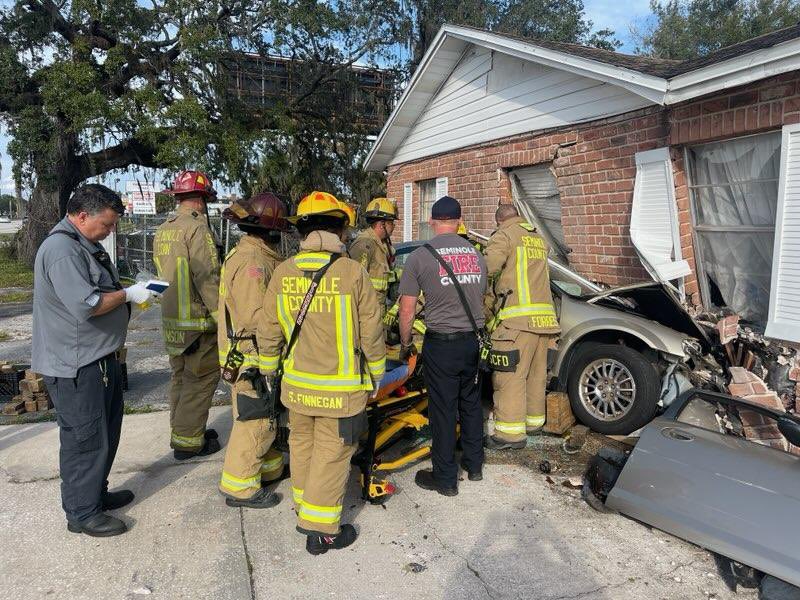 Crews work to free driver from vehicle that crashed into psychic shop