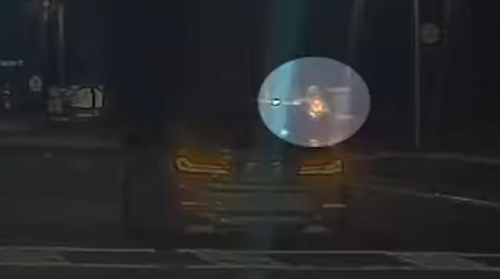 A passenger in the vehicle can be seen firing a gun while hanging out of the window. (Photo: Orange County Sheriff's Office)