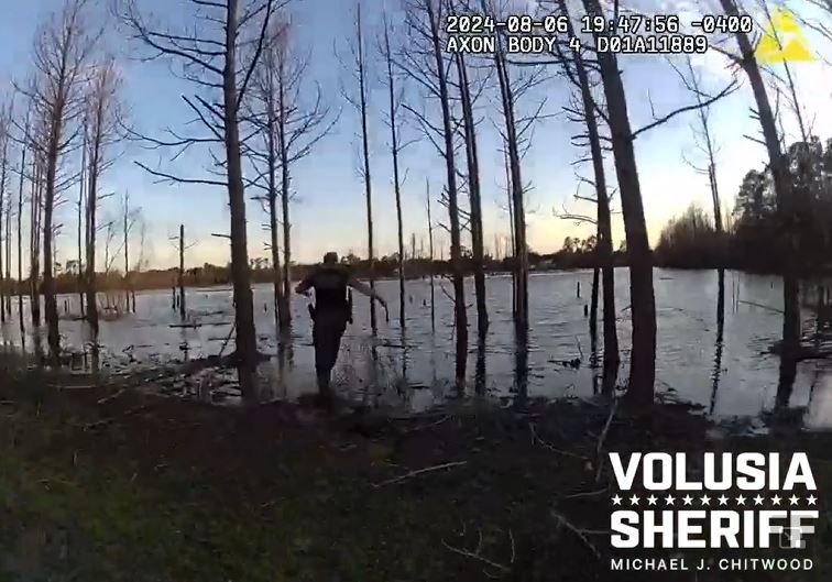 VCSO Deputy Wes Brough running into a pond in Deltona to rescue a missing 5-year-old boy with autism. (Photo: Volusia County Sheriff's Office)