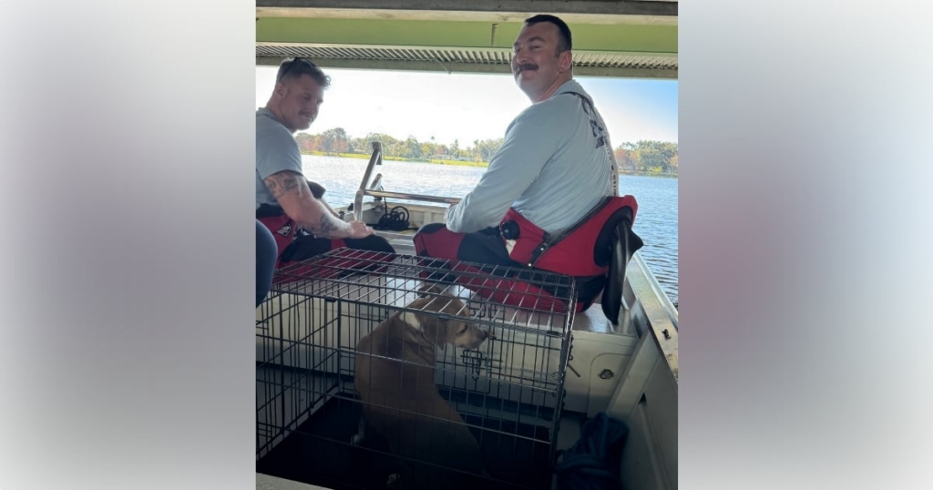 OFD's dive crew safely transporting the dog to a nearby boat ramp. (Photo: Orlando Fire Department)