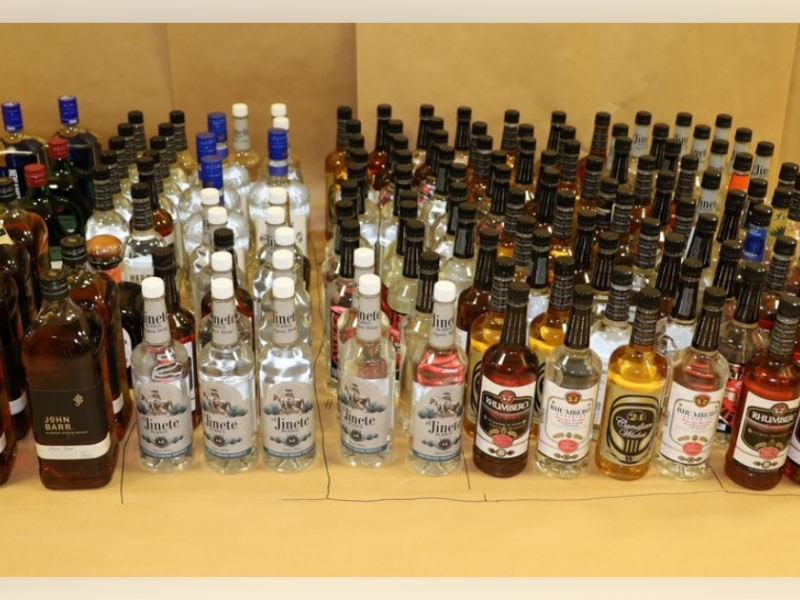 Dozens of bottles of liquor were seized by Kissimmee police during a search of a local lounge, leading to two arrests on illegal alcohol sale charges. (Photo: Kissimmee Police Department)