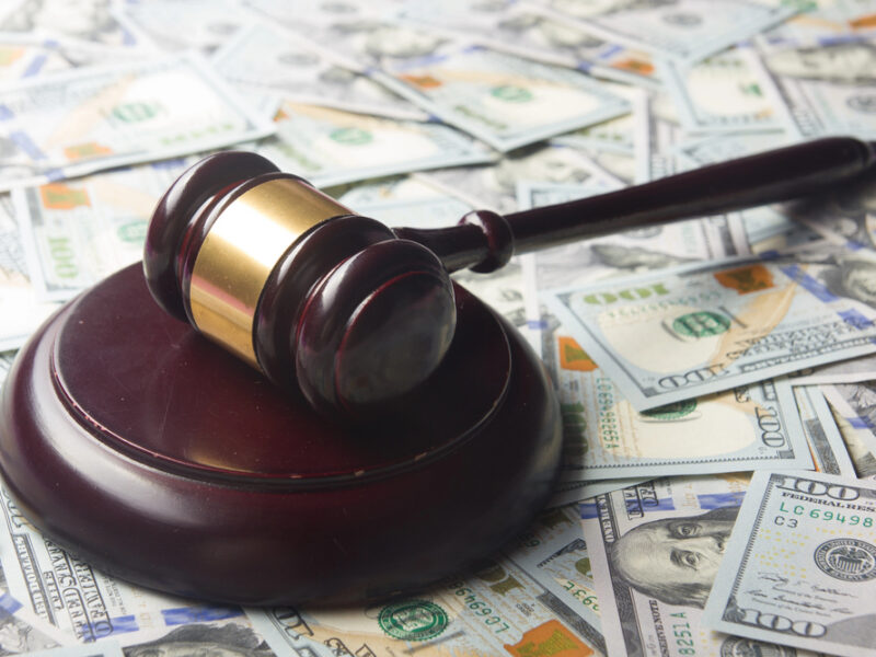 Gavel on pile of cash
