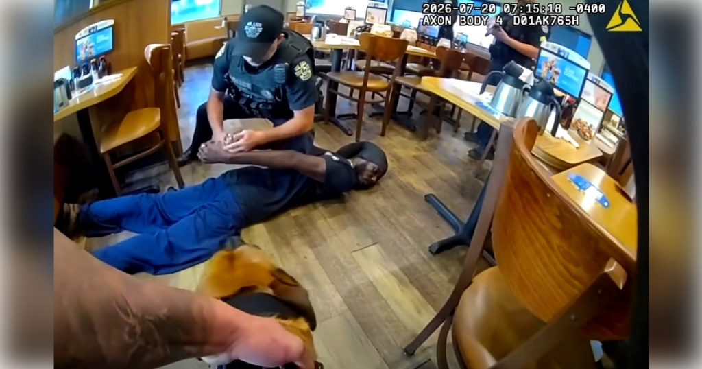 An OPD officer securing Jovaughn Nathan Matthie's wrists in handcuffs inside the IHOP on Monday morning. (Photo: Orlando Police Department)