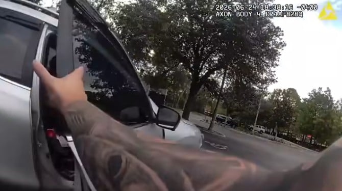 A male suspect, identified as 31 year old Lazaro Vela, attempting to flee from Apopka police on June 24, 2026. - officer grabbing passenger door photo by apopka police
