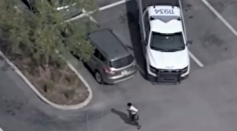 The suspect running from a patrol vehicle