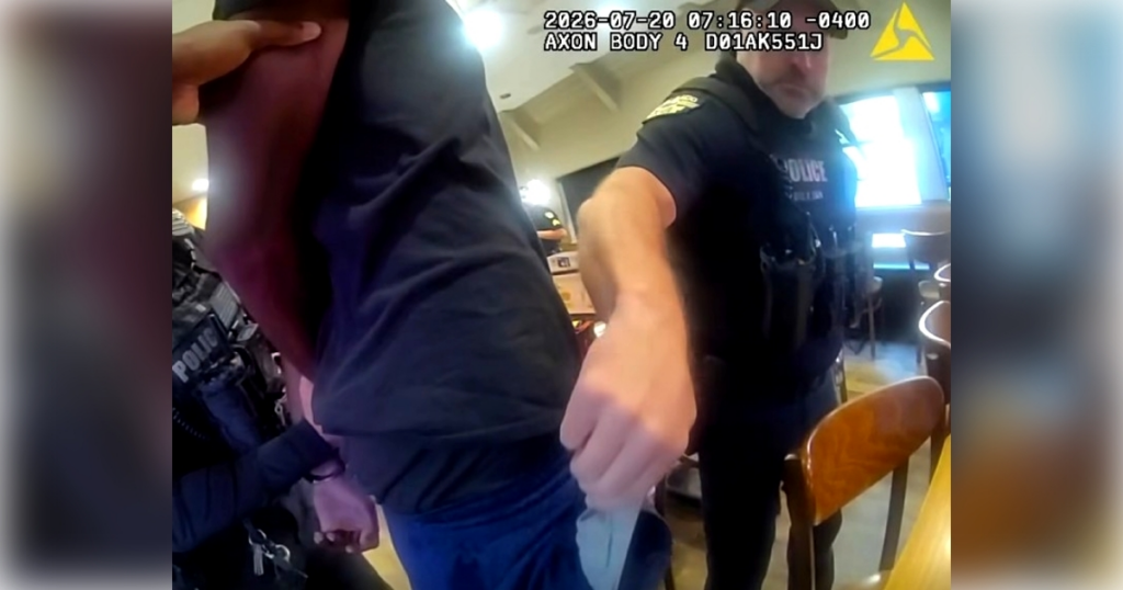 An OPD officer removing a wrapped object from one of Jovaughn Nathan Matthie's pockets, which the agency identified as a knife. (Photo: Orlando Police Department)